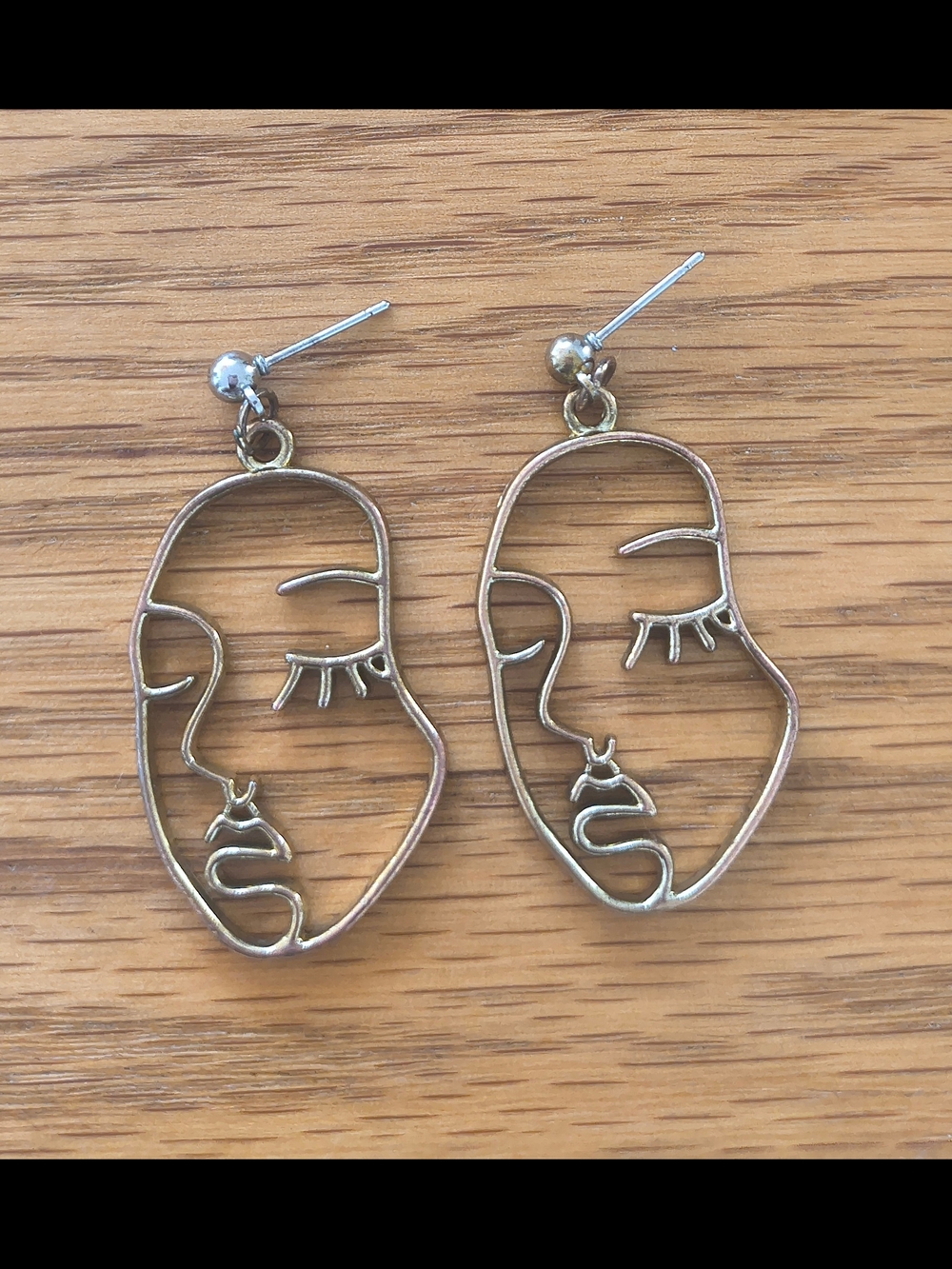Serious Face Outline Drop Gold Tone Earrings
